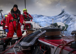 March 23, 2015. Leg 5 to Itajai onboard Dongfeng Race Team. Day 5. Martin Stromberg, Eric Peron and Liu Xue 'Black' on watch with Southern Ocean waves in the background.